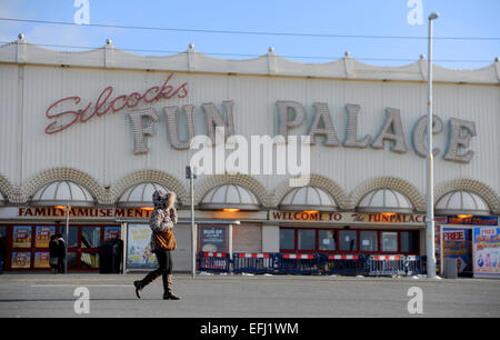 Blackpool Lancashire UK - Woman walks past the deserted Silcocks Fun Palace on cold winters day Stock Photo