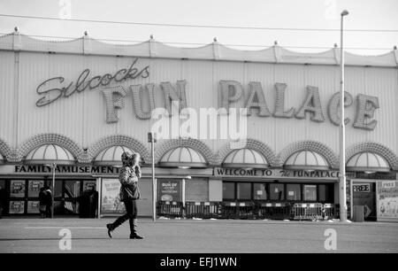 Blackpool Lancashire UK - Woman walks past the deserted Silcocks Fun Palace on cold winters day Stock Photo
