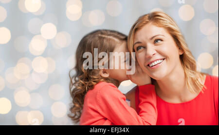 happy daughter whispering gossip to her mother Stock Photo