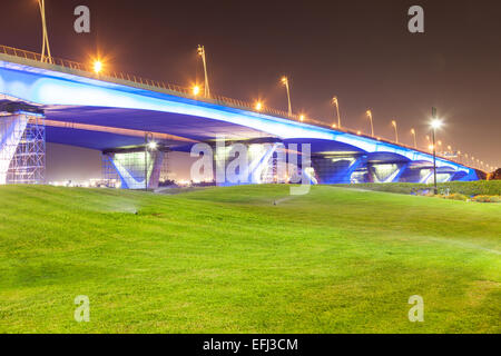 Blue illuminated Al Garhoud Bridge in Dubai, United Arab Emirates Stock Photo