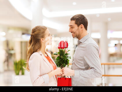 happy young couple with flowers in mall Stock Photo