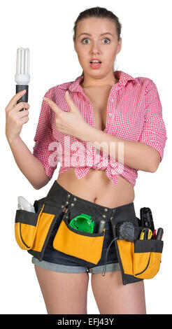 Woman in tool belt holding energy-saving lamp Stock Photo