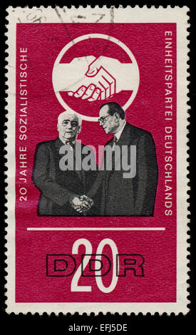 GERMAN DEMOCRATIC REPUBLIC - CIRCA 1966: A stamp printed in Germany shows the 20 years Socialist Unity Party of Germany, circa 1 Stock Photo