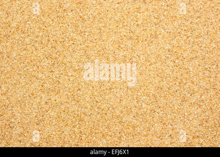 Closeup view from the top of coarse river sand which is light red in color. Stock Photo