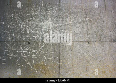 grungy concrete wall with many scratches on house foundation Stock Photo