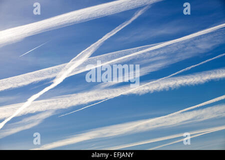 Con trails or vapour trails from high flying commercial aircraft Stock Photo