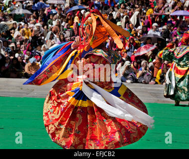 BHUTAN - Masked dancers reenact histories and myths to a packed house at the Trashi Chhoe Dzongduring during Thimphu Drubchen. Stock Photo