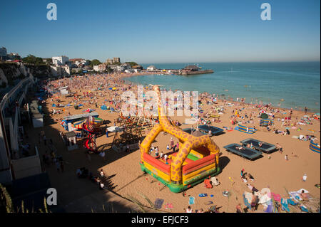 The crowded beach at Viking Bay, Broardstairs in Kent. On a summers day when the beach is full of people, the tide is in and there are swimm Stock Photo