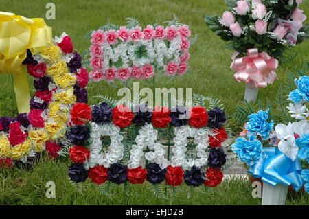 Memorial Day flowers atop grave sites. Stock Photo