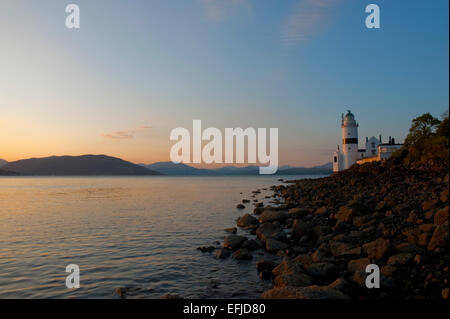 The cloch Lighthouse at sunset. Cloch or Cloch Point (Scottish Gaelic: stone) is a point on the coast of the Firth of Clyde, Sco Stock Photo