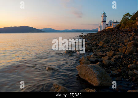 The cloch Lighthouse at sunset. Cloch or Cloch Point (Scottish Gaelic: stone) is a point on the coast of the Firth of Clyde, Sco Stock Photo