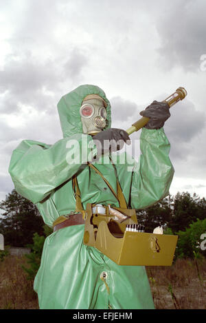 Soldier in protective suit reconnoiters chemical weapons Stock Photo