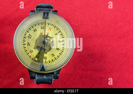 Vintage German WW2 airforce pilot wrist compass on red velvet background Stock Photo