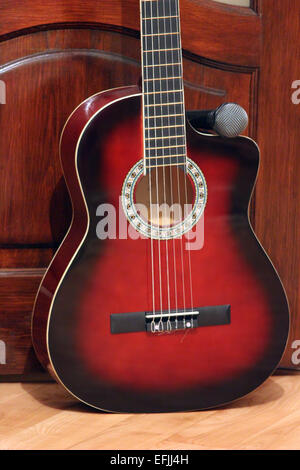 guitar and microphoneon the wooden dark background Stock Photo