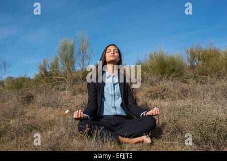 Young Latin woman doing yoga Stock Photo