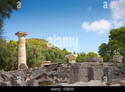 Ruins of the Temple of Zeus, with its single reconstructed Doric column at Ancient Olympia, The Peloponnese, Greece Stock Photo