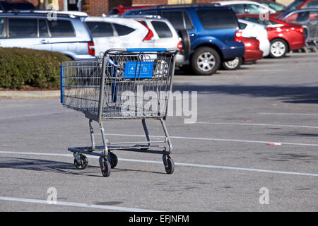 Single shopping cart in walmart parking lot. Stock Photo