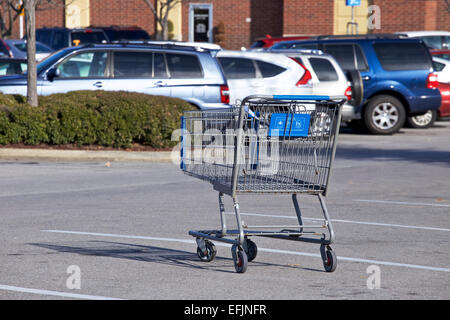 Single shopping cart in walmart parking lot. Stock Photo