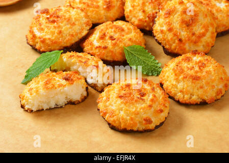 Coconut cookies dipped in dark chocolate on parchment paper Stock Photo