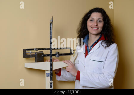 Portrait of a nutritionist next to weighing scales Stock Photo