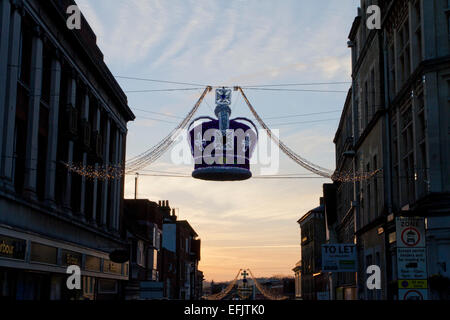 A purple Crown decorated with Christmas lights strung across Peascod Street, near Windsor Castle, Berkshire, England in January Stock Photo