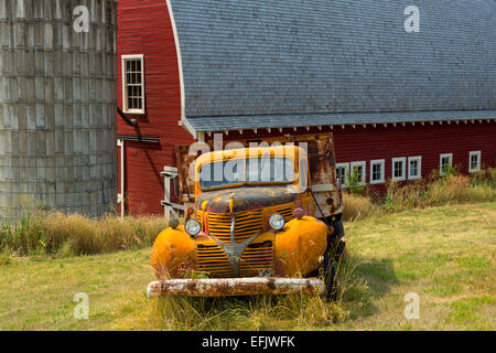 An old truck in front of a barn and silo in the Palouse. Washington. USA Stock Photo