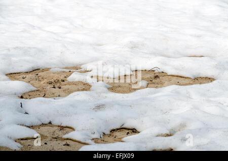 Melting snow on sandy beach of Upper Peninsula, Michigan Stock Photo
