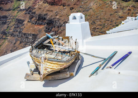 Old boat on roof of house and colorful old staircase in Santorini,Greece Stock Photo