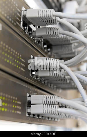 Patch Panel server rack with gray cords in the background Stock Photo