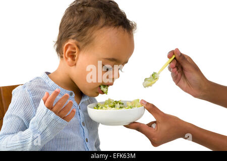 Little 18 month African toddler boy refusing to eat his vegetables Stock Photo