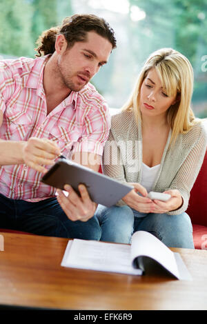 Couple working out finances Stock Photo