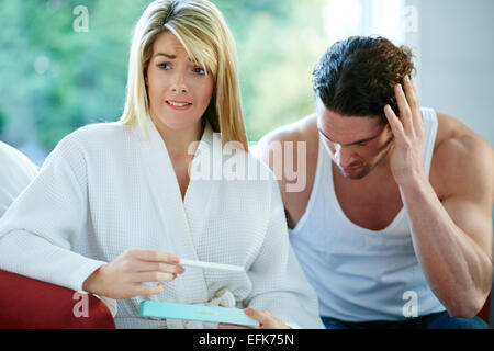 Unhappy couple finding out she is pregnant Stock Photo