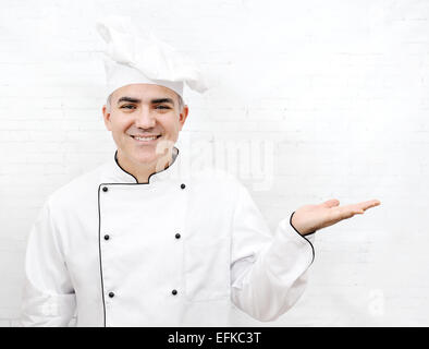 smiling chef dressed in white uniform Stock Photo