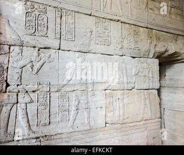 Egyptian bas relief on the stone facade of the temple Stock Photo