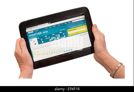 Woman's hands reading UK weather forecast using Google Nexus 10 tablet isolated on white background Stock Photo