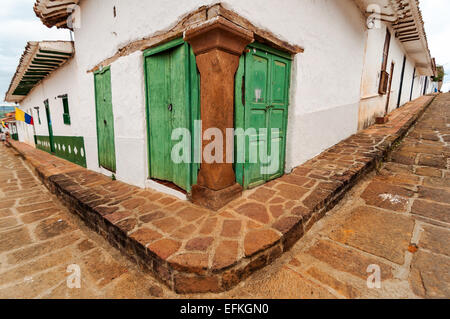 Street corner with an old colonial building with green doors in Barichara, Colombia Stock Photo