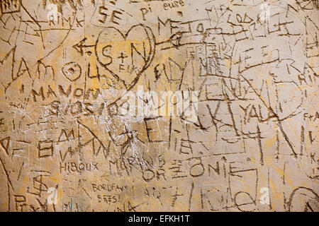 Messages engraved on a stone wall Stock Photo