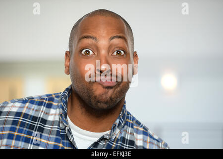 Young African American man making faces inside office building Stock Photo
