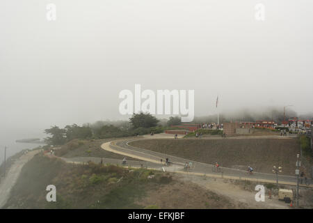 Foggy sky view from Golden Gate Bridge to Toll Plaza, Battery East Trail bluffs, people, tourists, San Francisco, USA Stock Photo
