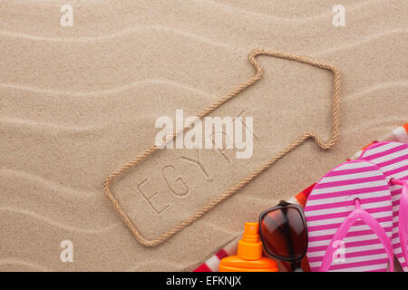 Egypt pointer and beach accessories lying on the sand, as background Stock Photo