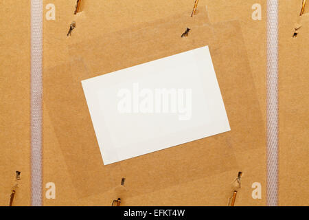 Cardboard Box with Large Staples, Plastic Straps and Blank Label. Stock Photo