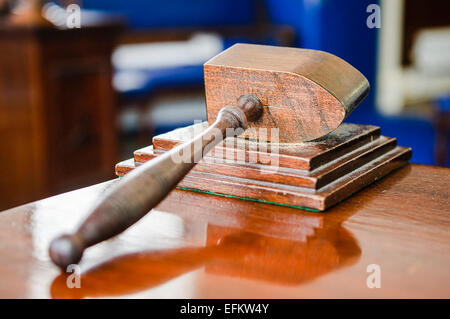 Wooden hammer sits on a table in a Craft Lodge room in a Masonic hall. Stock Photo
