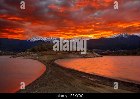 Sunset at Plastiras lake, Karditsa, Thessaly, Greece. In the background, Agrafa mountains Stock Photo