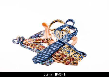 A heap of different ties lying mixed up on a white isolated background. Stock Photo