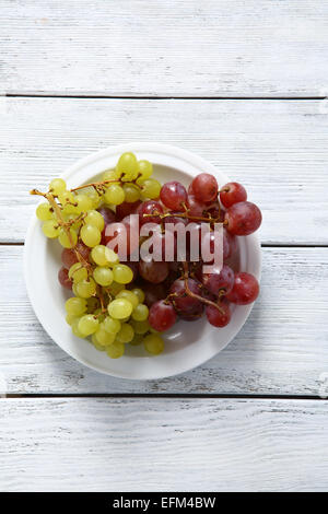 Grapes on a white plate, fruit Stock Photo
