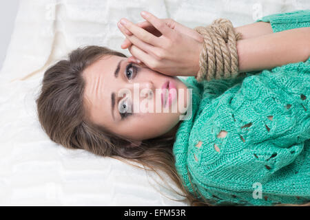 girl with his hands tied. crying. Stock Photo