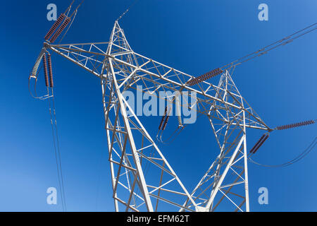 Electricity pylon against blue sky Stock Photo