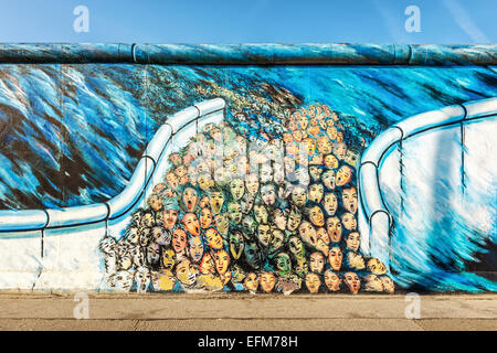 Graffiti art depicting people escaping East Berlin on Berlin wall at East Side Gallery, Berlin, Germany, Europe Stock Photo