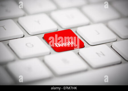 The word "DONATE" written on metallic keyboard Stock Photo
