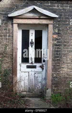 Weathered white front door on a derelict cottage on Orchard Street, Cambridge, UK Stock Photo